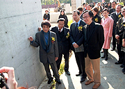 Mr. Tadao Ando in front of a sample of fair-faced concrete