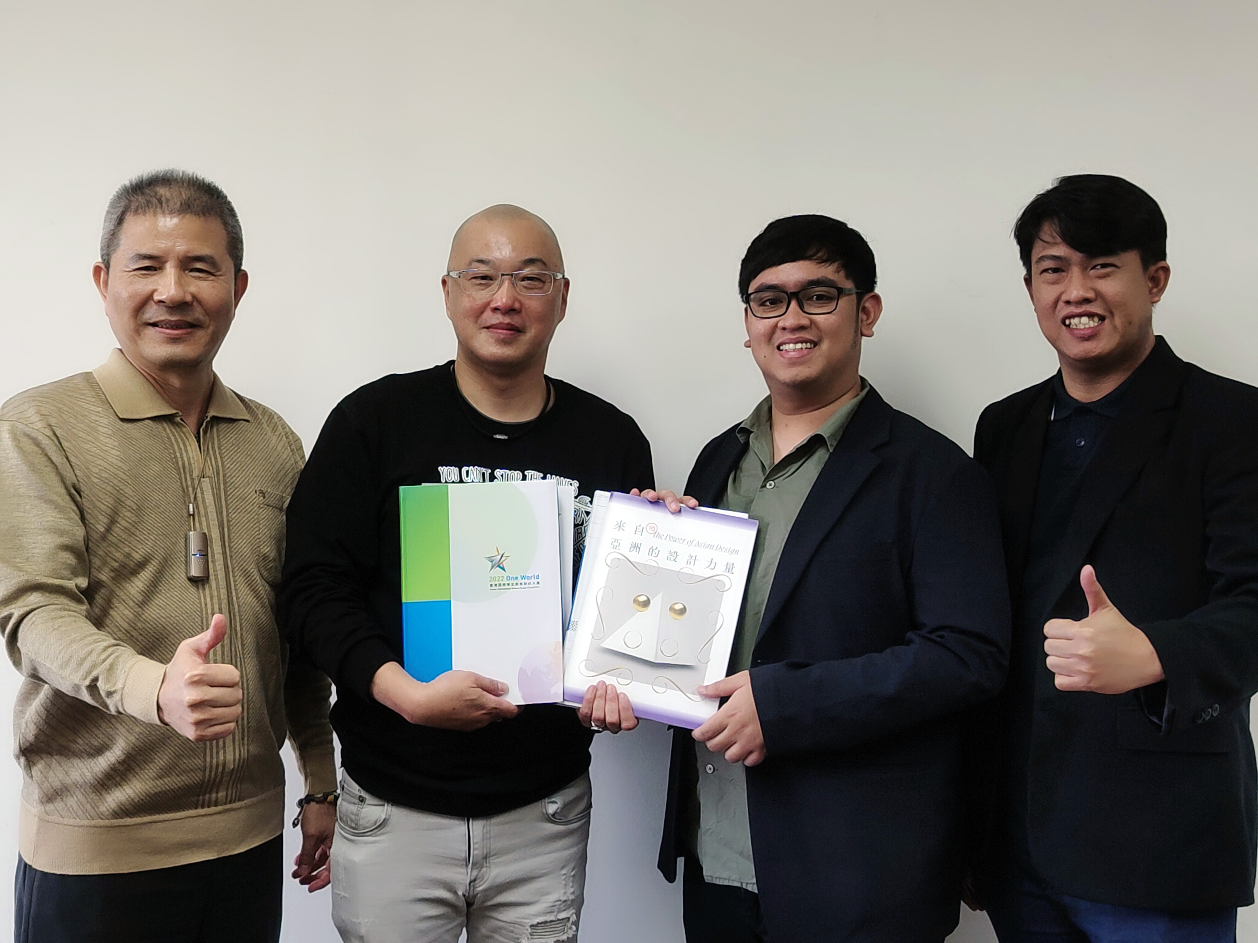 (from left to right) Asia University's Vice President Chi-Hsiung Chen, Department Chair Xiao-Wei Fang of Visual Communication Design, presenting materials on Asia University's design activities such as the "Taiwan International Student Design Competition" and "The Power of Asian Design 