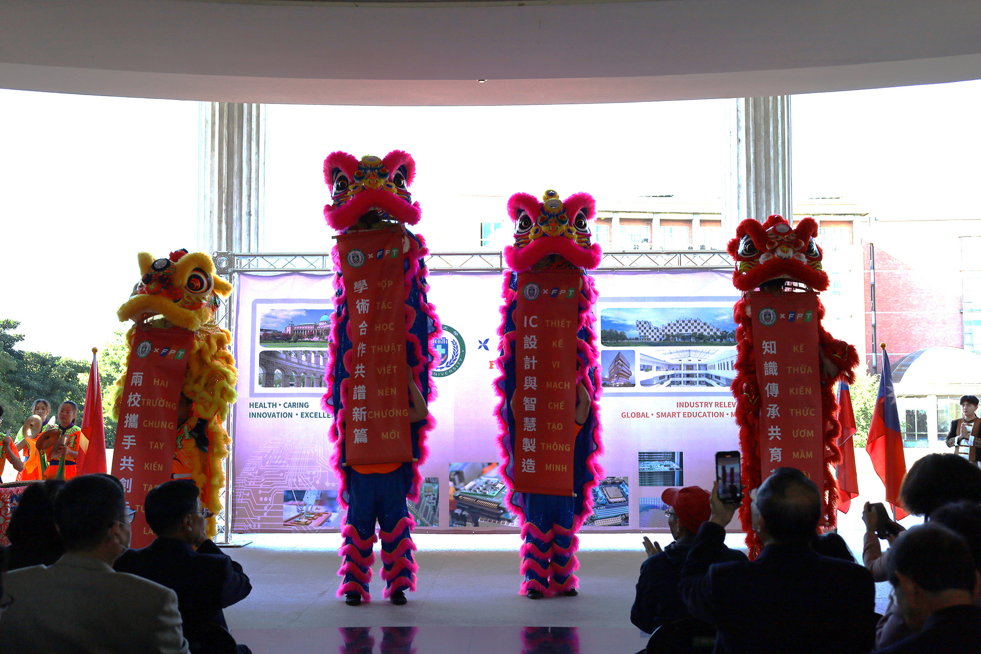 The lion dance performance features banners celebrating the partnership and joint efforts in nurturing smart technology talent, sparking cheers from the crowd