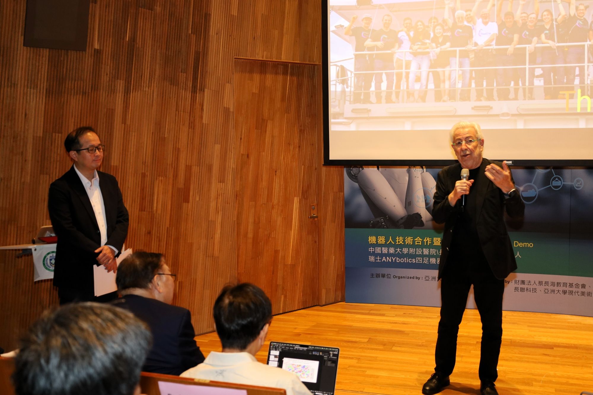 Oussama Khatib emphasizes that human–robot collaboration extends human expertise and judgment into high-risk environments such as the deep sea and disaster zones; pictured with Asia University Vice President Jung-Jie Huang (left).